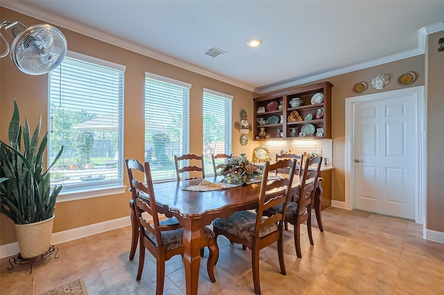 dining area featuring light tile patterned floors, visible vents, baseboards, and ornamental molding