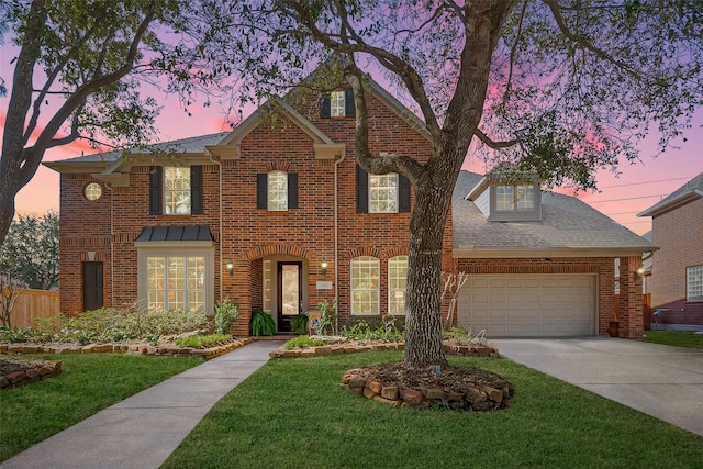 view of front of home with a lawn, roof with shingles, concrete driveway, a garage, and brick siding