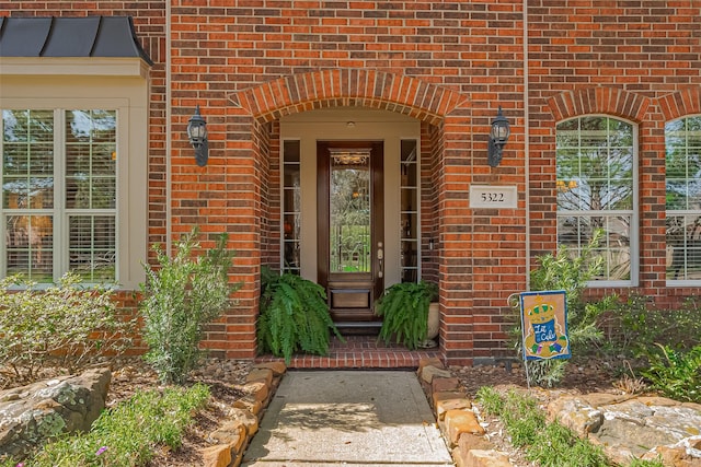 doorway to property with brick siding