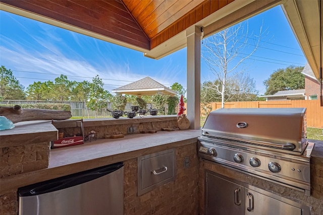 view of patio with a gazebo, area for grilling, and a fenced backyard