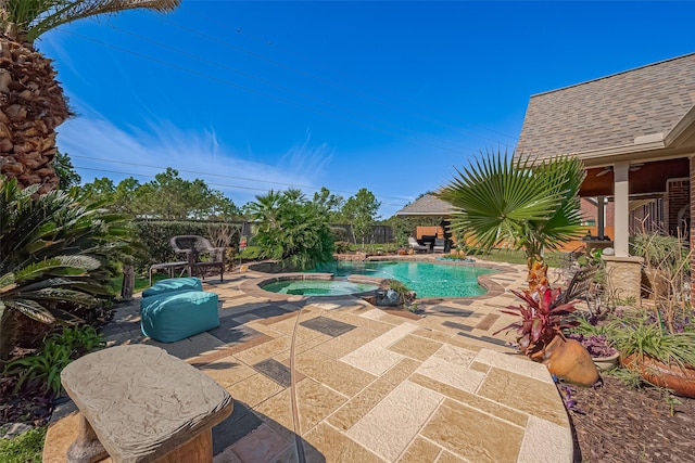 view of swimming pool with a patio area and a pool with connected hot tub