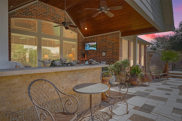 view of patio / terrace featuring outdoor dry bar, ceiling fan, and fence