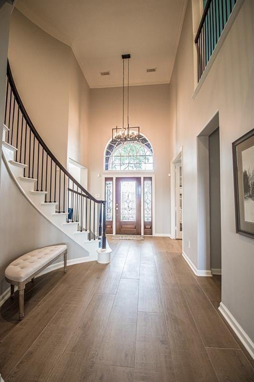 foyer featuring stairs, baseboards, and wood-type flooring