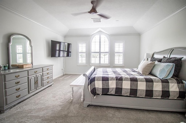 bedroom with visible vents, lofted ceiling, light colored carpet, and crown molding