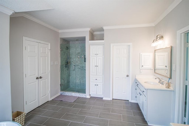 full bathroom featuring vanity, crown molding, baseboards, and a stall shower