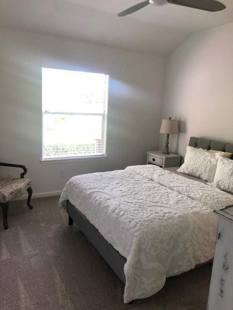 bedroom featuring vaulted ceiling, baseboards, carpet floors, and ceiling fan