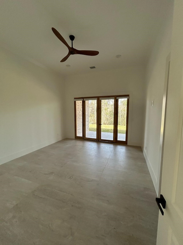 unfurnished room featuring visible vents, a ceiling fan, concrete floors, and baseboards