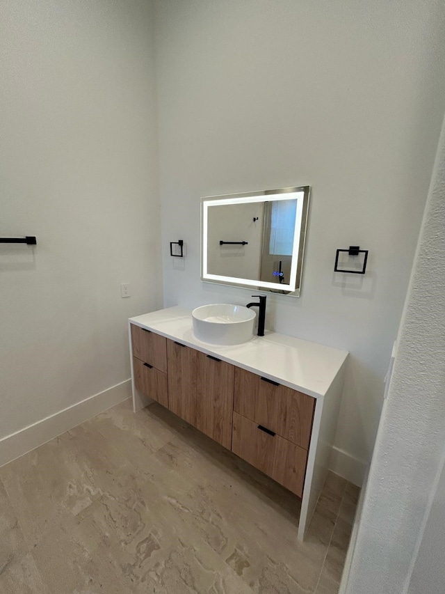 bathroom with vanity and baseboards