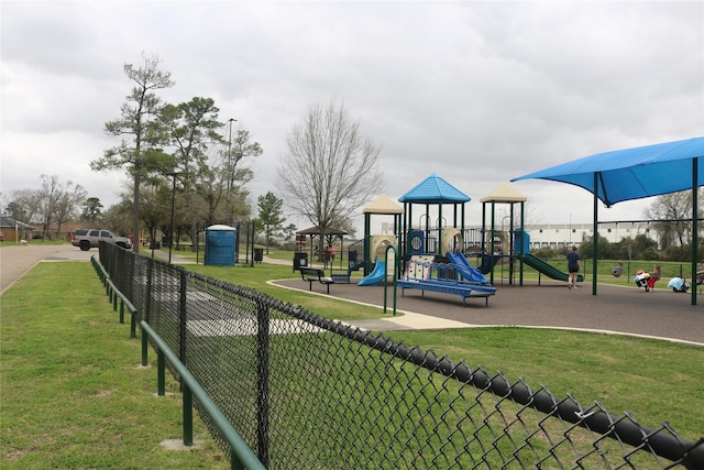 community playground featuring a yard and fence