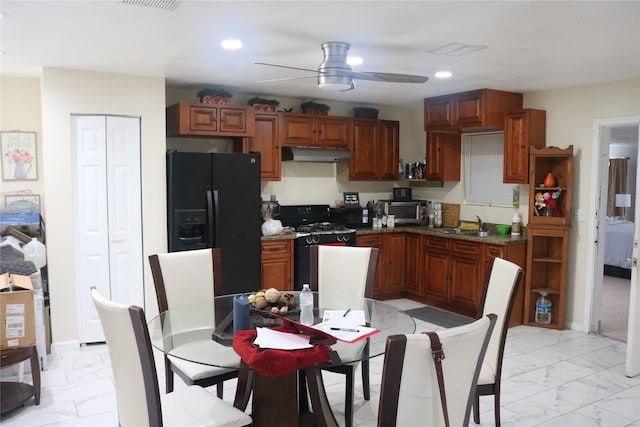 kitchen with marble finish floor, black fridge, under cabinet range hood, recessed lighting, and range with gas cooktop