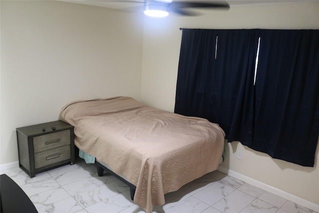 bedroom featuring marble finish floor, baseboards, and ceiling fan