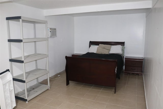 bedroom with a wall mounted air conditioner and light tile patterned flooring