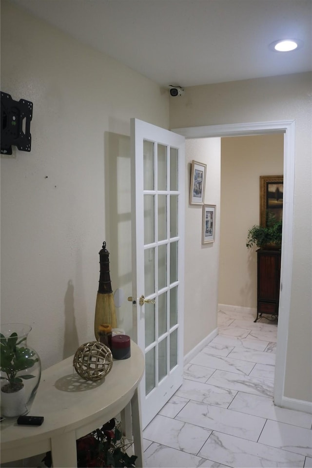 corridor with marble finish floor, french doors, and baseboards