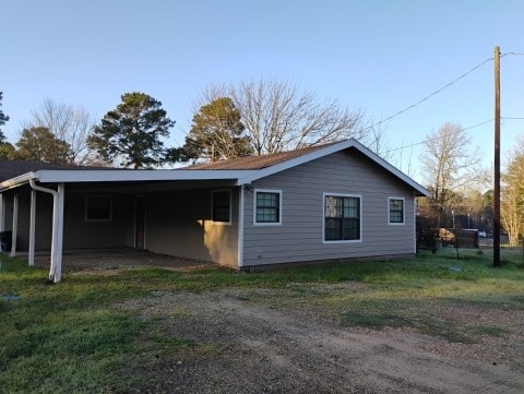 view of side of property featuring a carport