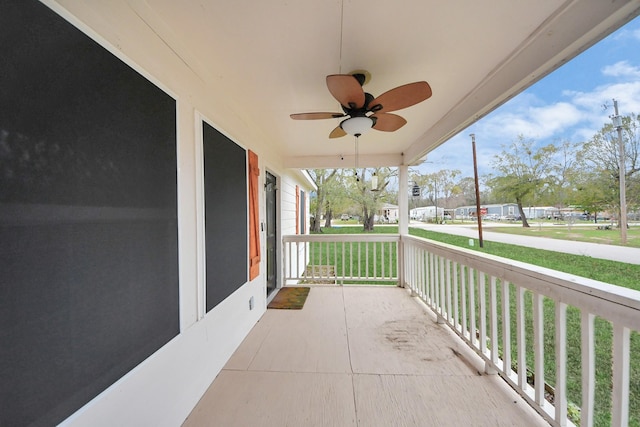 exterior space with a porch and ceiling fan