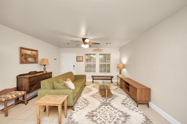 living room featuring visible vents, light tile patterned floors, a ceiling fan, and baseboards