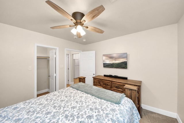 bedroom featuring baseboards, carpet, ceiling fan, and freestanding refrigerator