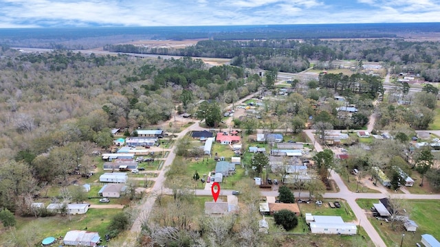 birds eye view of property with a wooded view