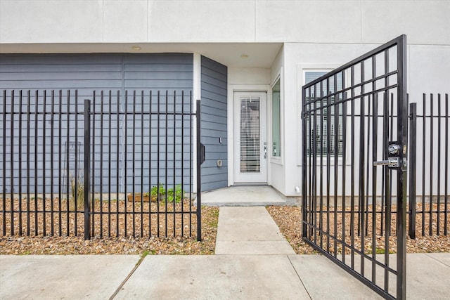 view of exterior entry with a gate and fence