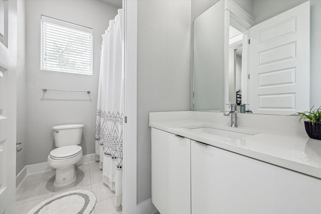 full bathroom with tile patterned flooring, toilet, vanity, and baseboards