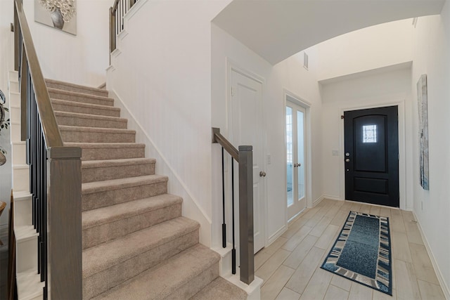 entryway featuring stairway, baseboards, and wood tiled floor