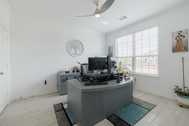 office space featuring baseboards, visible vents, light wood finished floors, ceiling fan, and ornamental molding