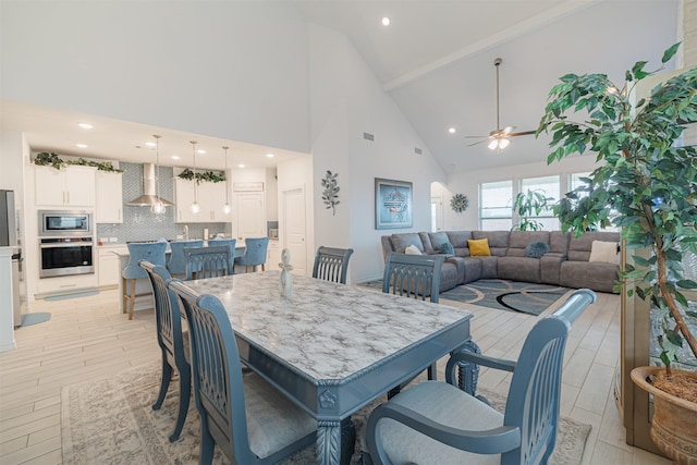 dining room featuring visible vents, high vaulted ceiling, a ceiling fan, recessed lighting, and light wood-style floors