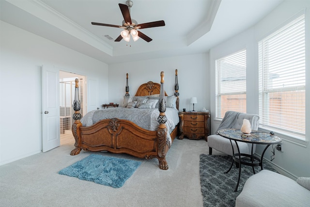 bedroom featuring visible vents, baseboards, a tray ceiling, ornamental molding, and carpet floors