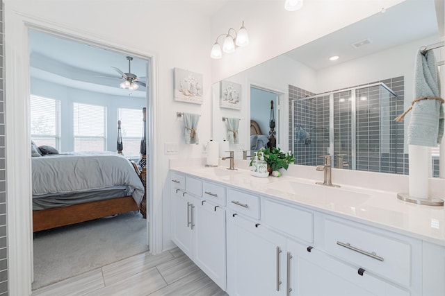 ensuite bathroom with connected bathroom, a stall shower, and a sink