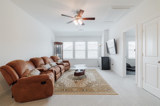 living room featuring visible vents, plenty of natural light, light colored carpet, and a ceiling fan