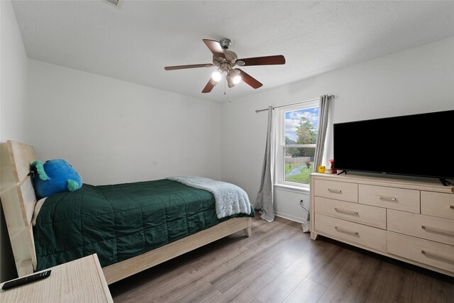 bedroom featuring dark wood-type flooring and ceiling fan