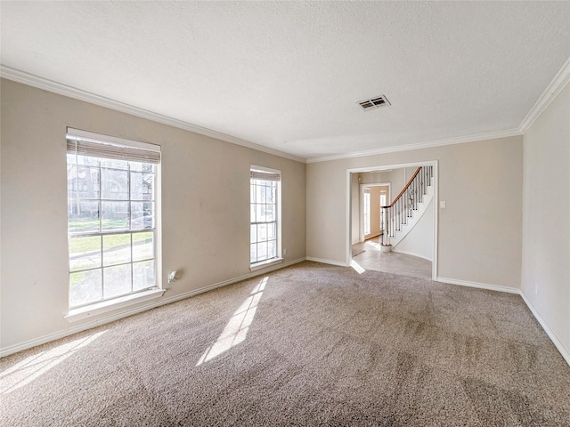 unfurnished room featuring stairway, visible vents, a textured ceiling, crown molding, and carpet flooring