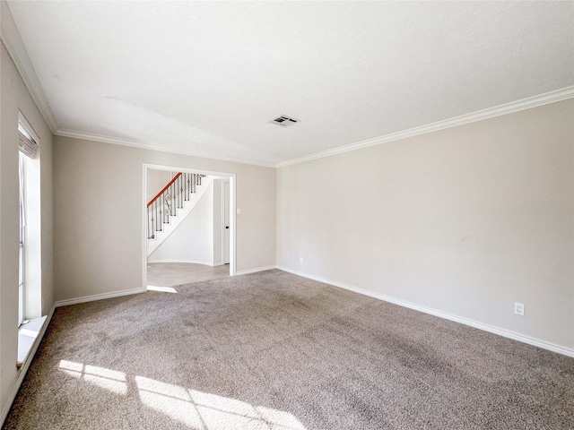 carpeted empty room with stairway, baseboards, visible vents, and ornamental molding