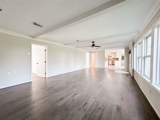 unfurnished living room featuring visible vents, crown molding, baseboards, beamed ceiling, and dark wood-style flooring