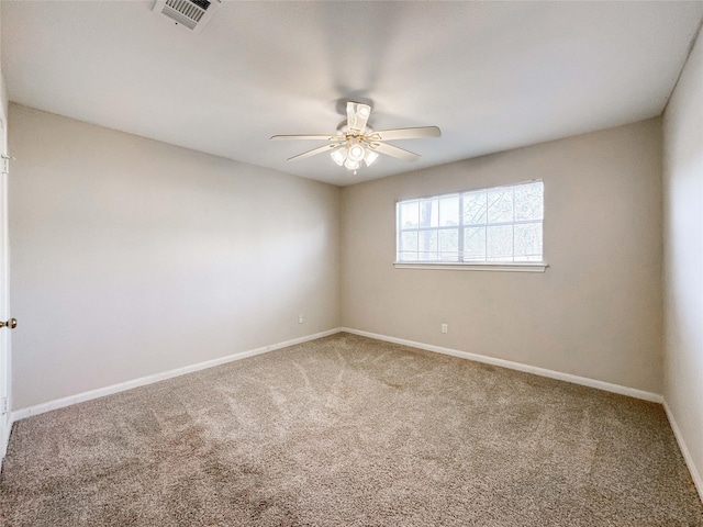 empty room featuring visible vents, a ceiling fan, baseboards, and carpet floors