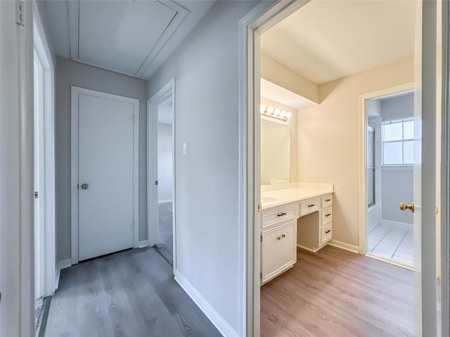 full bathroom with vanity,  shower combination, wood finished floors, and baseboards