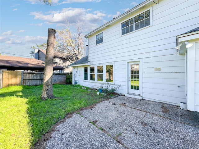 back of house with a patio, a yard, and fence