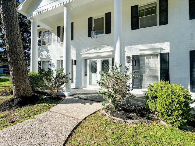 view of front of house with brick siding and covered porch