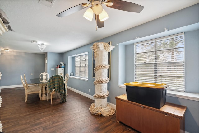 dining space with visible vents, a healthy amount of sunlight, and dark wood-style flooring