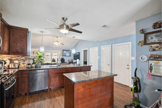 kitchen featuring visible vents, gas range oven, dishwashing machine, a peninsula, and a sink