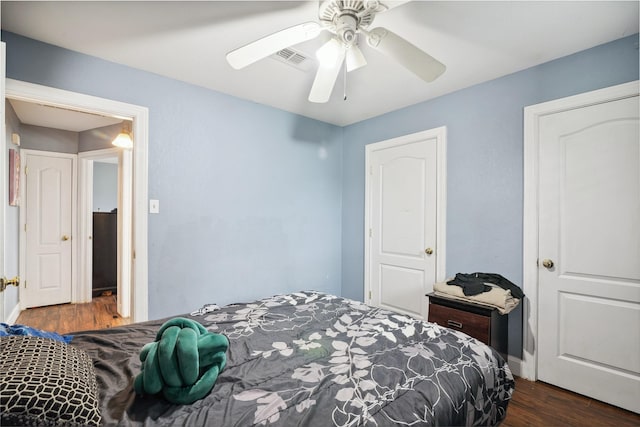 bedroom with visible vents, ceiling fan, and dark wood-style flooring