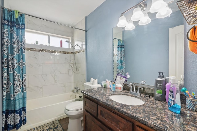 full bathroom with vanity, toilet, a textured wall, and shower / bath combo with shower curtain