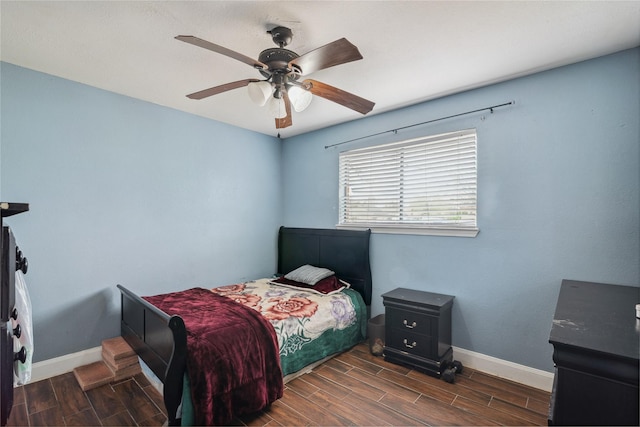 bedroom featuring ceiling fan, baseboards, and wood finish floors