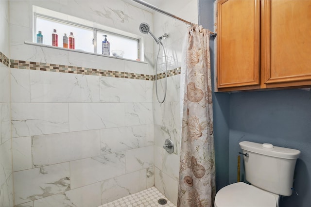 full bath featuring toilet and a tile shower