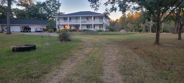 3902 Moore Cemetery Rd, Groveton, TX 75845 - view of front of house featuring a front lawn, dirt driveway, and a balcony