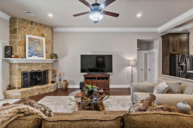 living area featuring a fireplace, crown molding, baseboards, and dark wood-style flooring