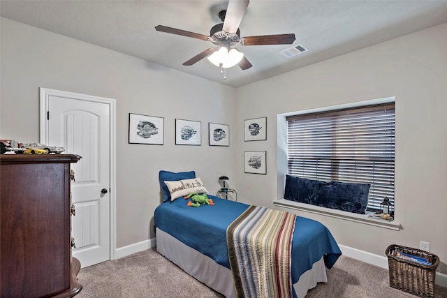 carpeted bedroom with baseboards, visible vents, and ceiling fan