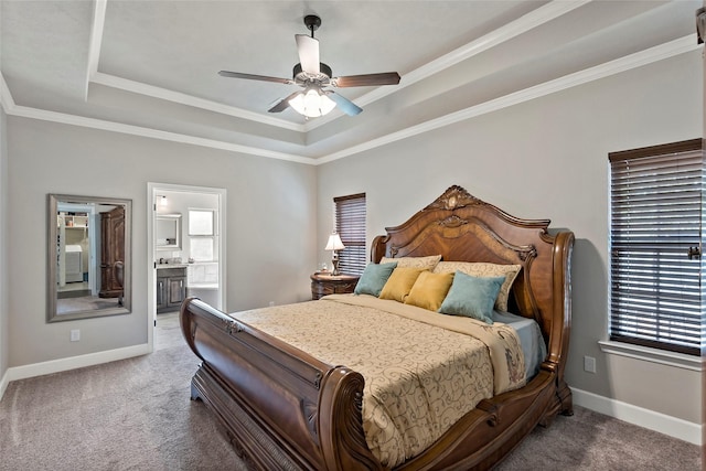 bedroom featuring a tray ceiling, carpet floors, baseboards, and ornamental molding