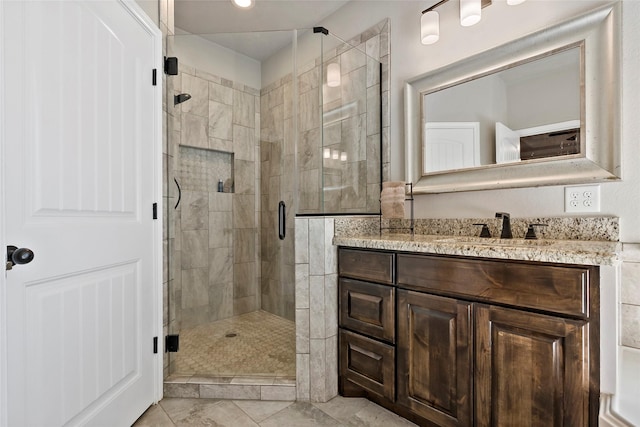 bathroom featuring a stall shower and vanity