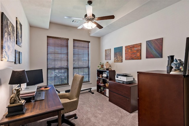 carpeted office space featuring visible vents, baseboards, and a ceiling fan